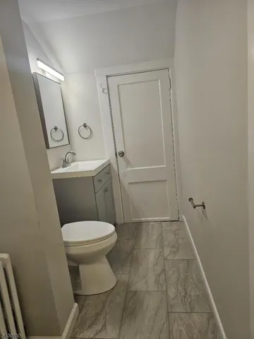 a white toilet sitting next to a bathroom sink