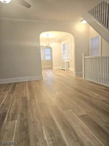 a view of an empty room and wooden floor