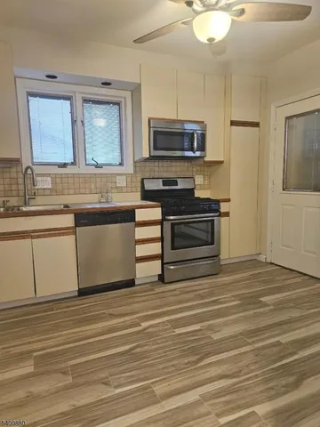 a view with a sink and a microwave