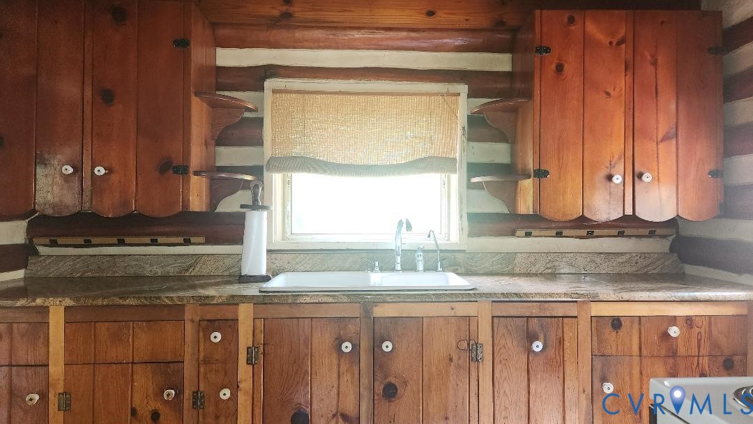 415 Springdale Avenue Colonial Heights, VA 23834 - Photo 6 of 21 a kitchen with granite countertop a sink a stove and wooden cabinets