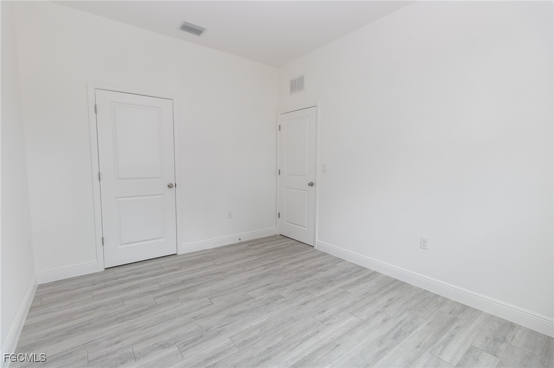 3032 West Briarwood Road LaBelle, FL 33935 - Photo 15 of 23 a view of an empty room with wooden floor