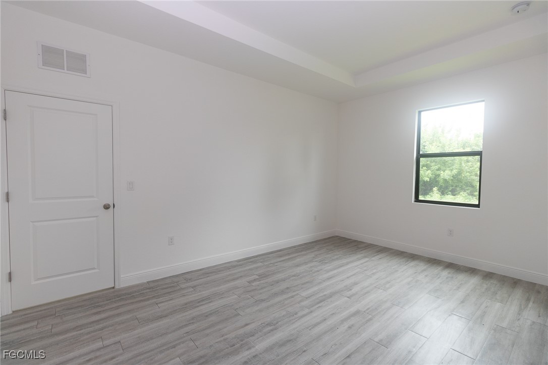 3032 West Briarwood Road LaBelle, FL 33935 - Photo 17 of 23 an empty room with wooden floor and windows