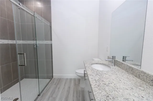 a bathroom with a granite countertop sink and toilet