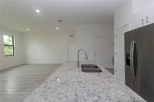 a view of a refrigerator in kitchen and a window