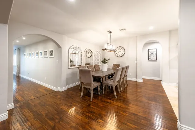 a kitchen with granite countertop stainless steel appliances a refrigerator a sink and cabinets