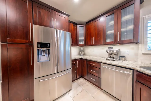 a bathroom with a granite countertop sink and mirror