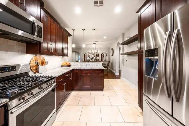 a white toilet sitting next to a window in a bathroom
