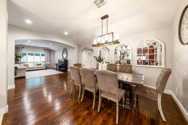a bathroom with a granite countertop sink mirror vanity and toilet