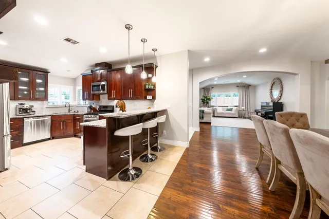 a bath tub sitting next to a white sink and a shower