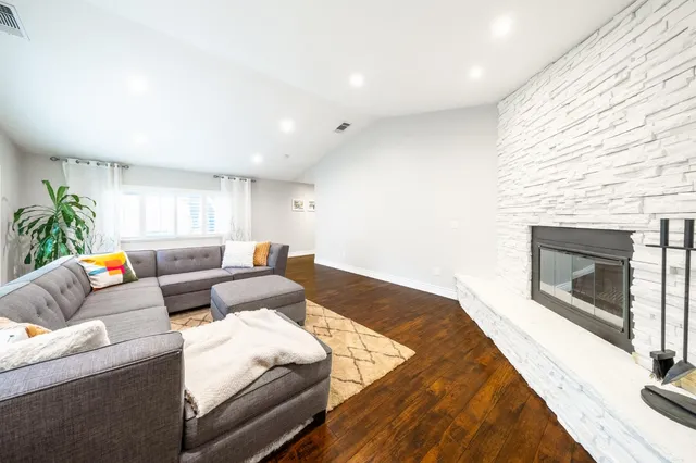a view of a house with a patio and a yard