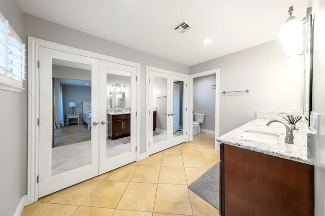 a bathroom with a sink mirror toilet and shower