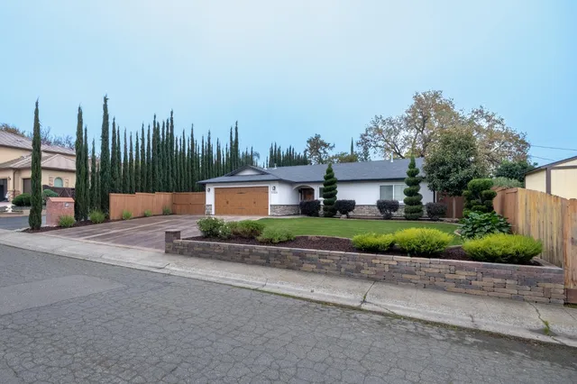 a front view of a house with garden