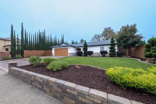 a dining room with furniture a chandelier and wooden floor