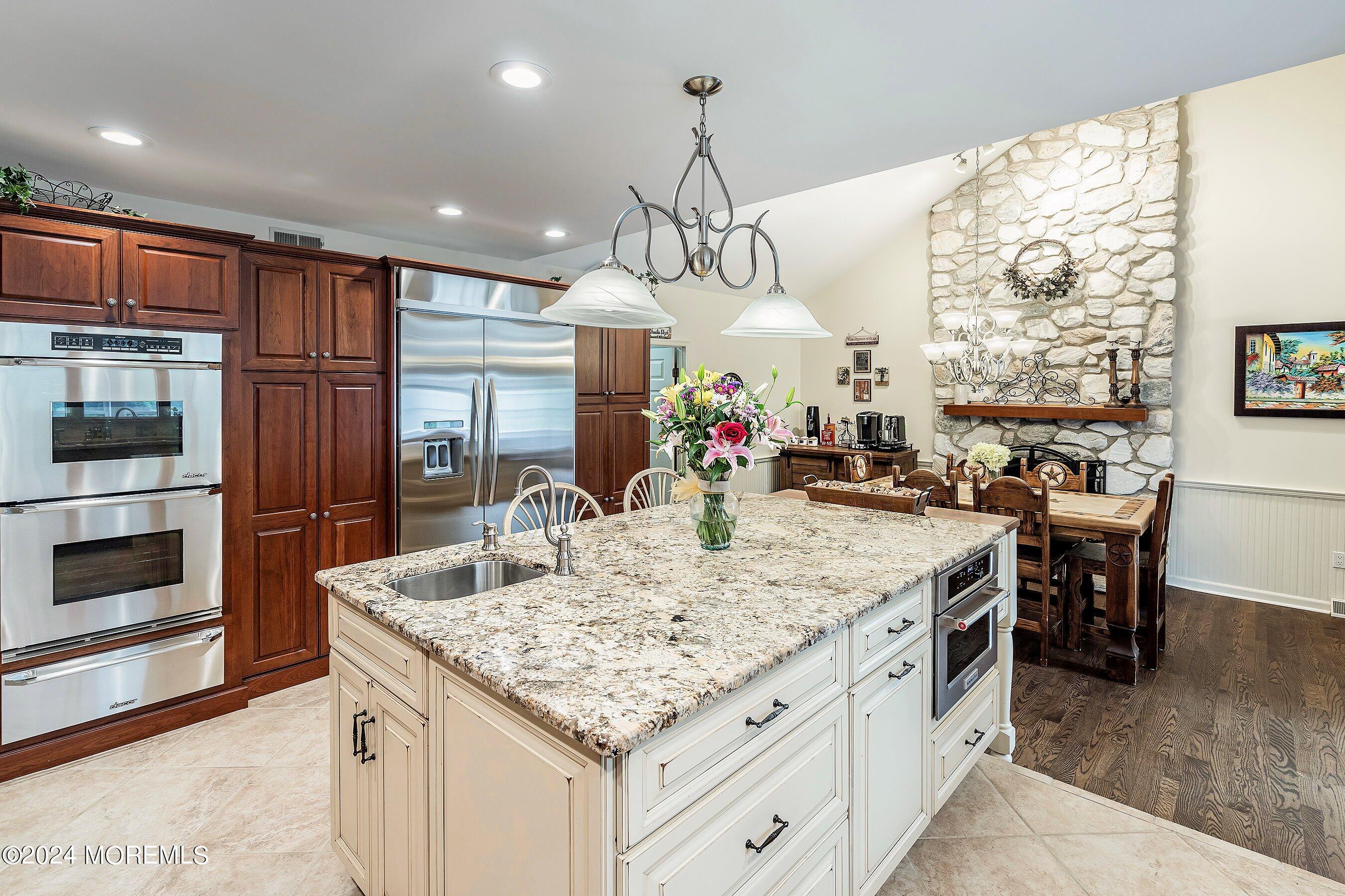 2 Pullen Drive Millstone Township, NJ 08535 - Photo 19 of 87 a kitchen with stainless steel appliances granite countertop a table chairs and a refrigerator