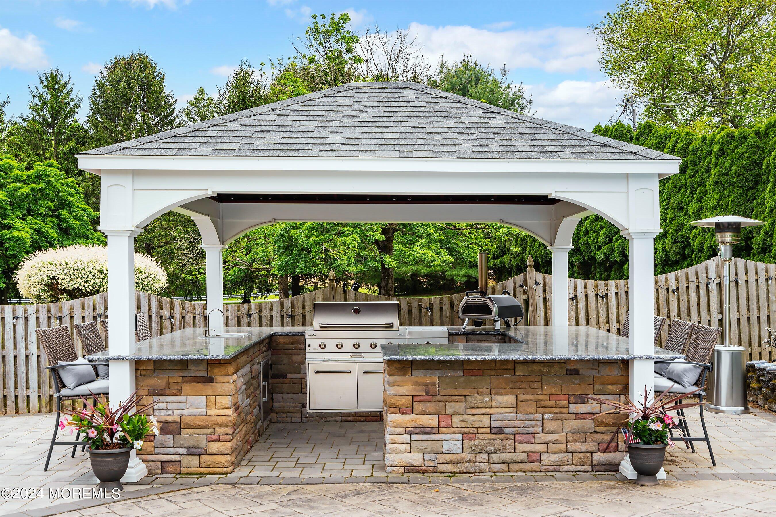2 Pullen Drive Millstone Township, NJ 08535 - Photo 73 of 87 a view of patio with table and chairs potted plants and a palm tree