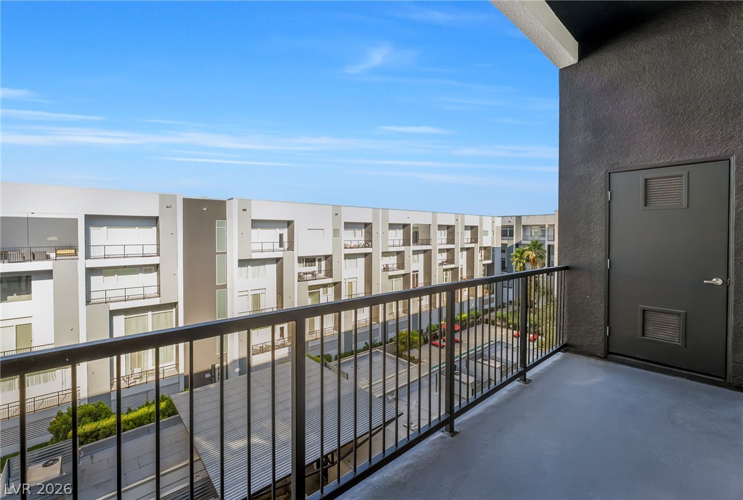 2775 West Pebble Road, Unit 505 Las Vegas, NV 89123 - Photo 17 of 26 A spacious private balcony overlooks a modern residential complex.