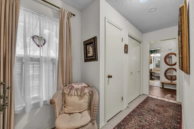 a hallway with painting and table