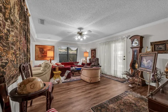 a living room with furniture a window and gym equipment