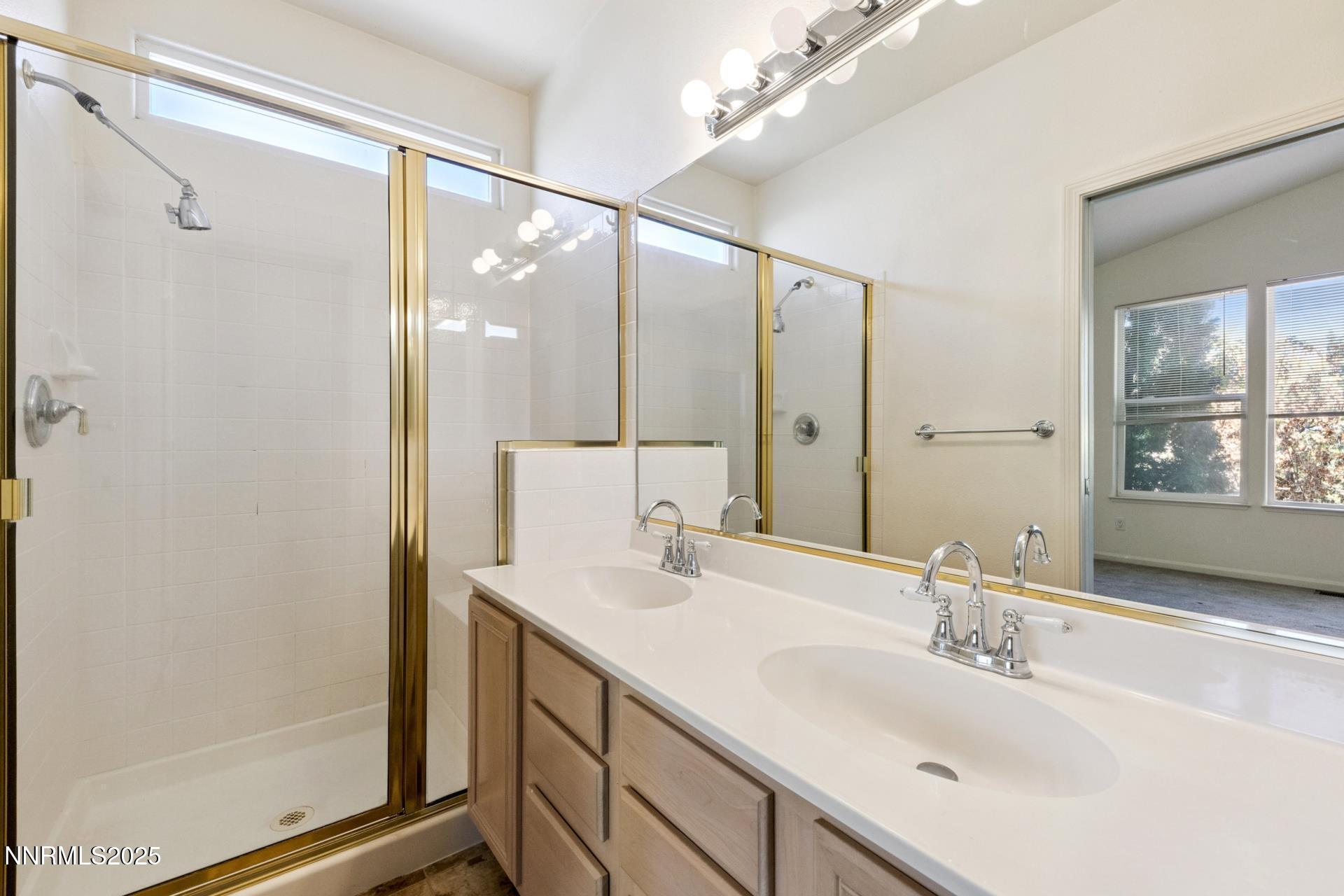 709 Caughlin Glen Reno, NV 89519 - Photo 22 of 41 a bathroom with a double vanity sink mirror and shower