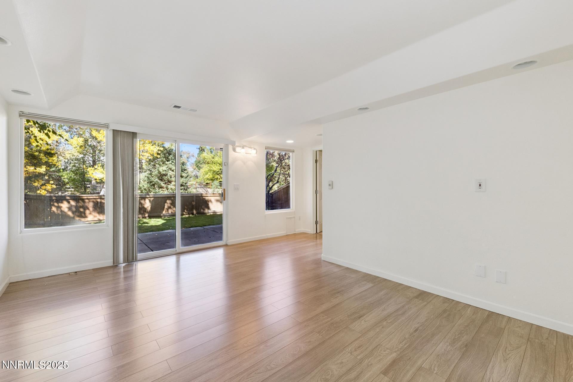 709 Caughlin Glen Reno, NV 89519 - Photo 24 of 41 an empty room with wooden floor and windows
