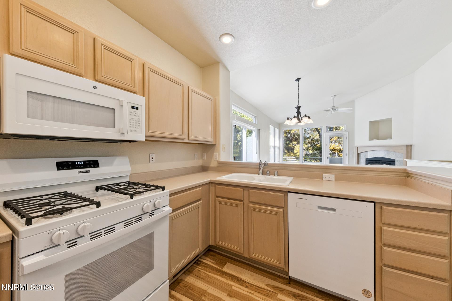 709 Caughlin Glen Reno, NV 89519 - Photo 6 of 41 a kitchen with stainless steel appliances granite countertop a sink stove and cabinets