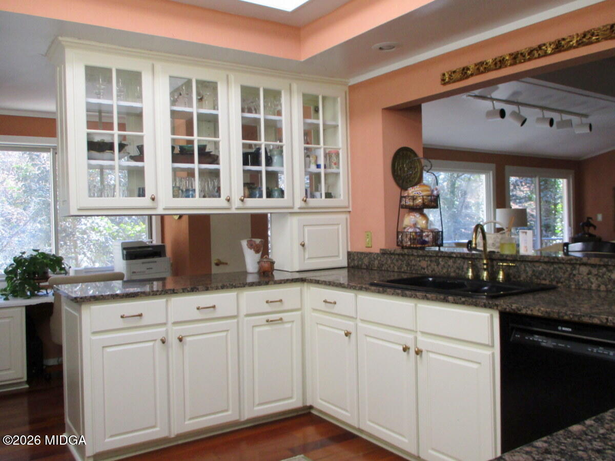 1121 South Jackson Springs Road Macon, GA 31211 - Photo 15 of 29 a kitchen with granite countertop white cabinets and a sink