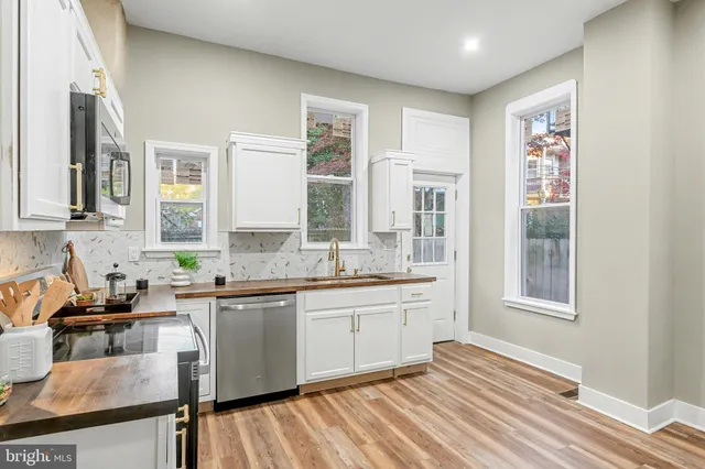 a kitchen with granite countertop a sink and cabinets