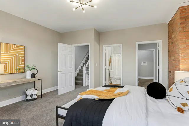 a bedroom with a bed and a chandelier