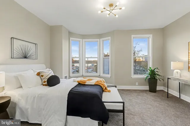 a bedroom with a bed and window