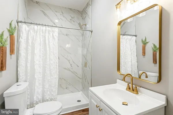 a bathroom with a sink toilet and shower