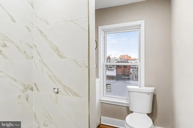 a white toilet sitting next to a bathroom sink