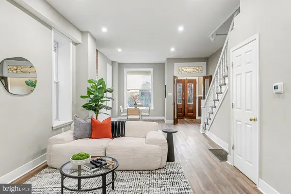a living room with furniture and a potted plant