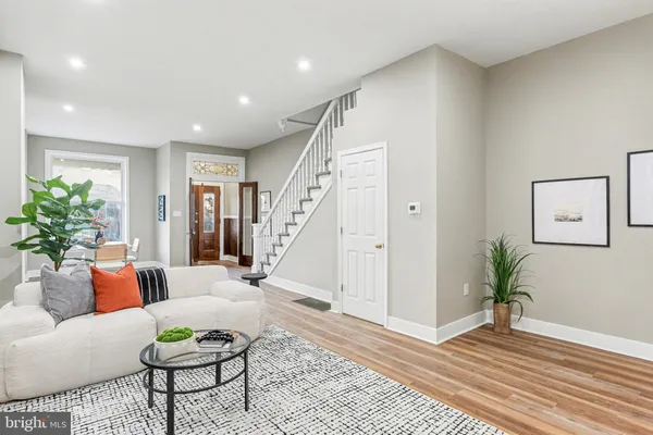 a living room with furniture and wooden floor