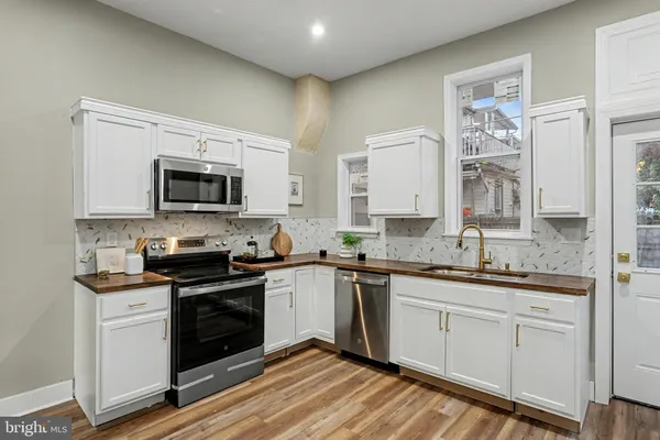 a kitchen with a sink cabinets and stainless steel appliances