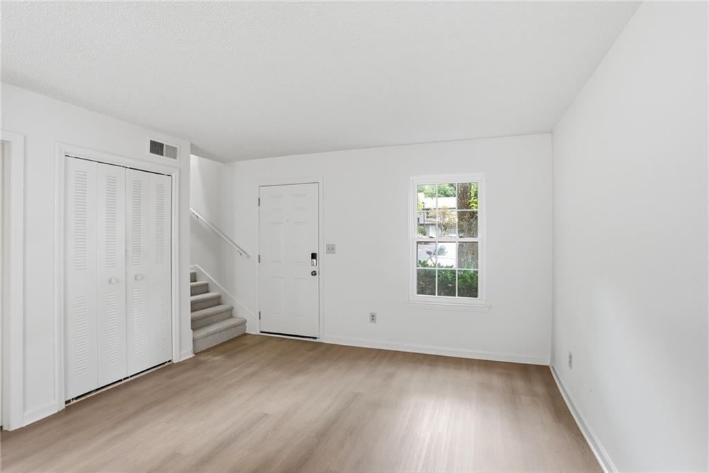 413 Promenade Court Marietta, GA 30064 - Photo 13 of 28 an empty room with wooden floor and windows
