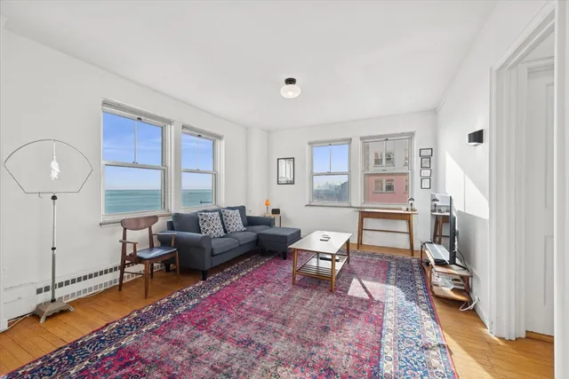 a view of a livingroom with workspace and a window