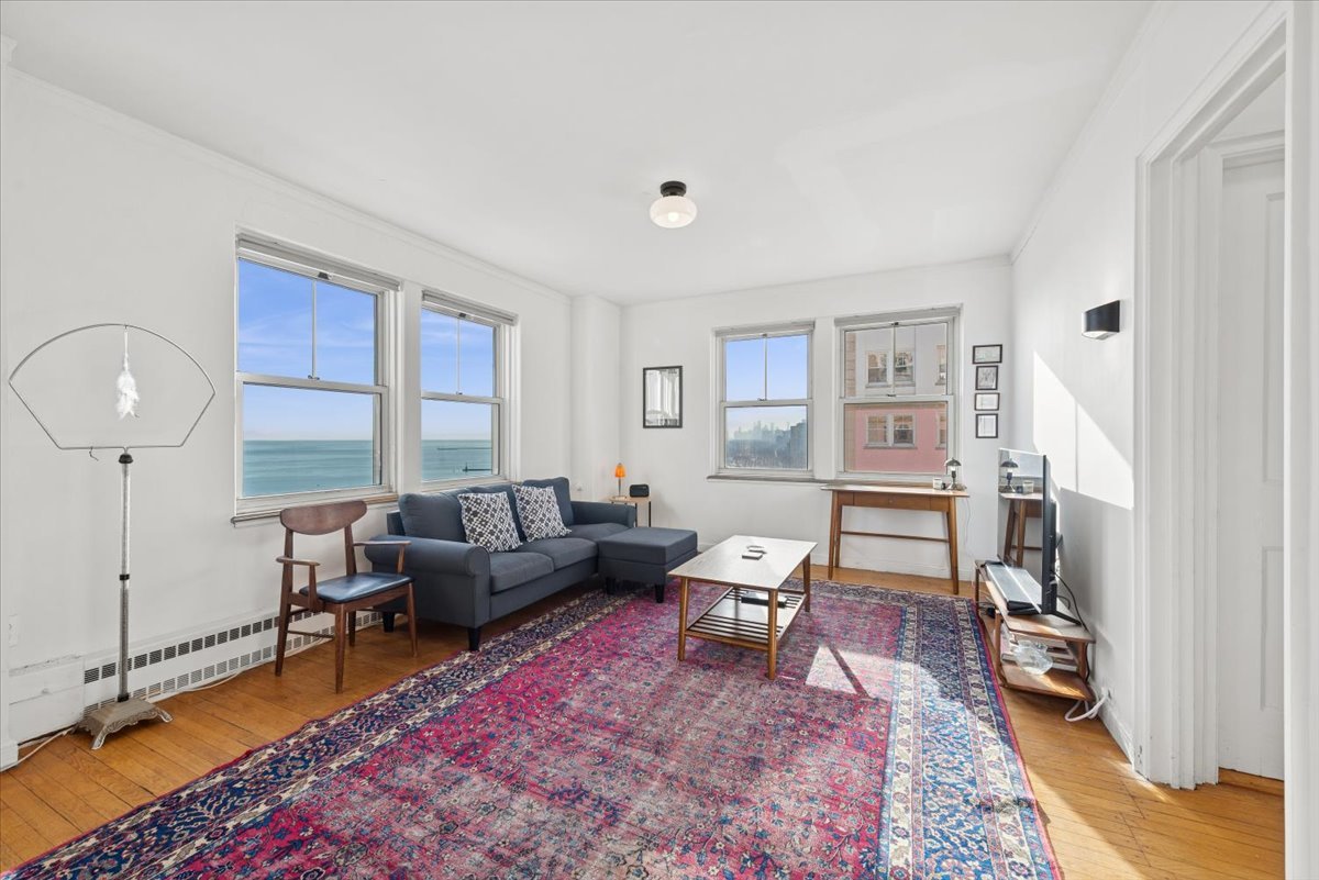 5555 North Sheridan Road, Unit 1716 Chicago, IL 60640 - Photo 7 of 24 a living room with furniture a rug and a large window