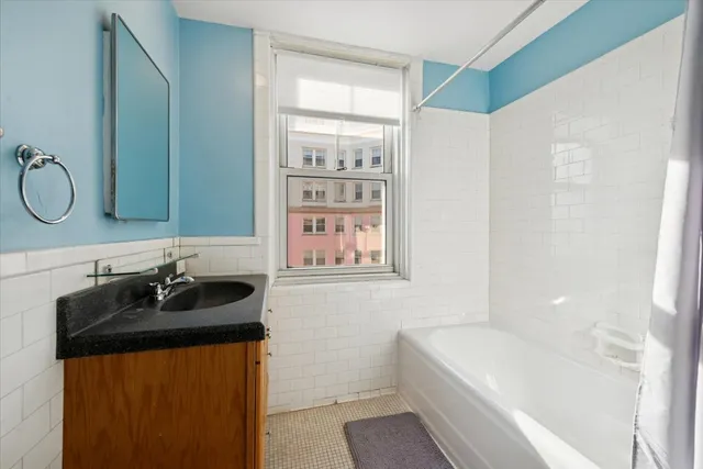 a kitchen with granite countertop a black refrigerator oven a sink and dishwasher