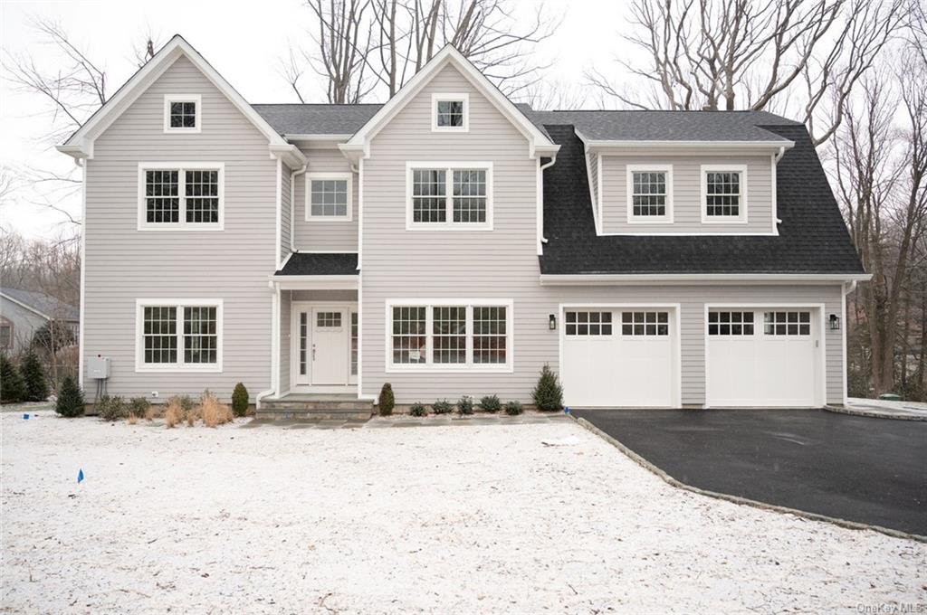 32 Lincoln Avenue Rye Brook, NY 10573 - Photo 1 of 1 a front view of a house with a yard covered in snow