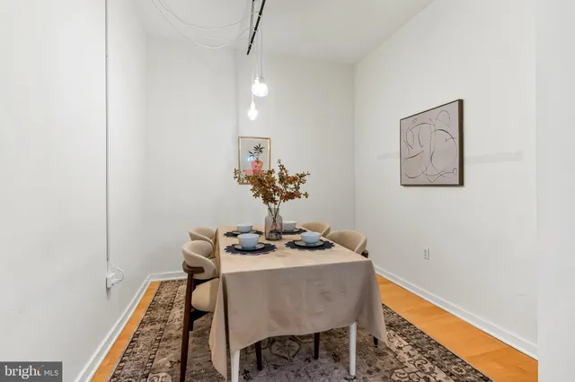 a dining room with furniture and wooden floor