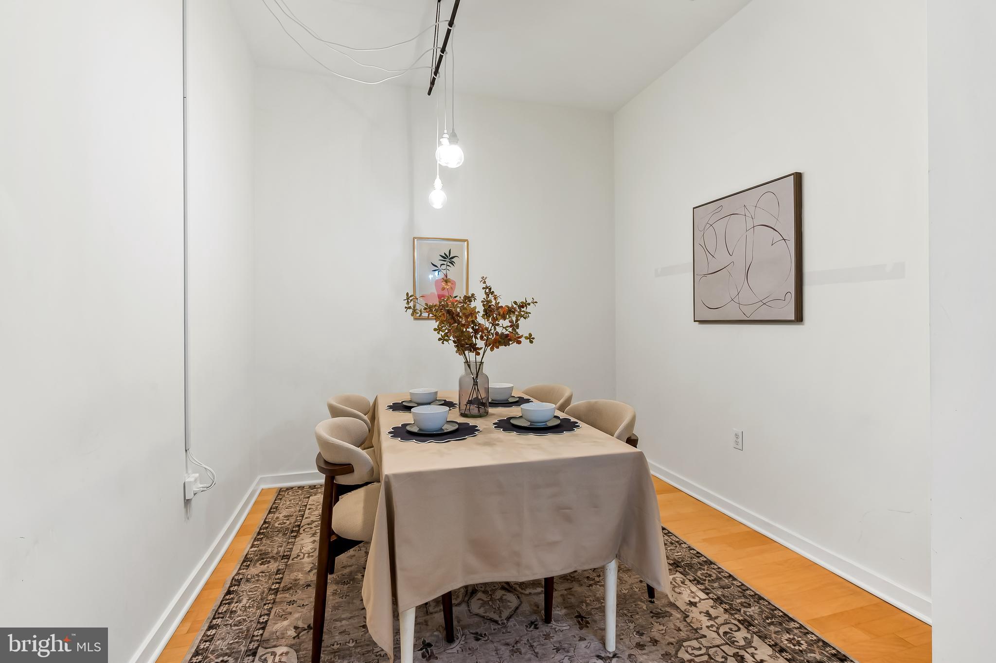1209 North Charles Street, Unit 314 Baltimore, MD 21201 - Photo 16 of 34 a dining room with furniture and wooden floor