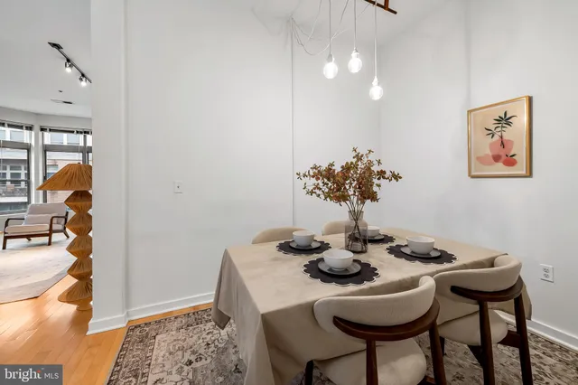 a dining room with furniture and wooden floor