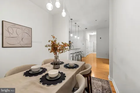 a dining room with furniture and wooden floor