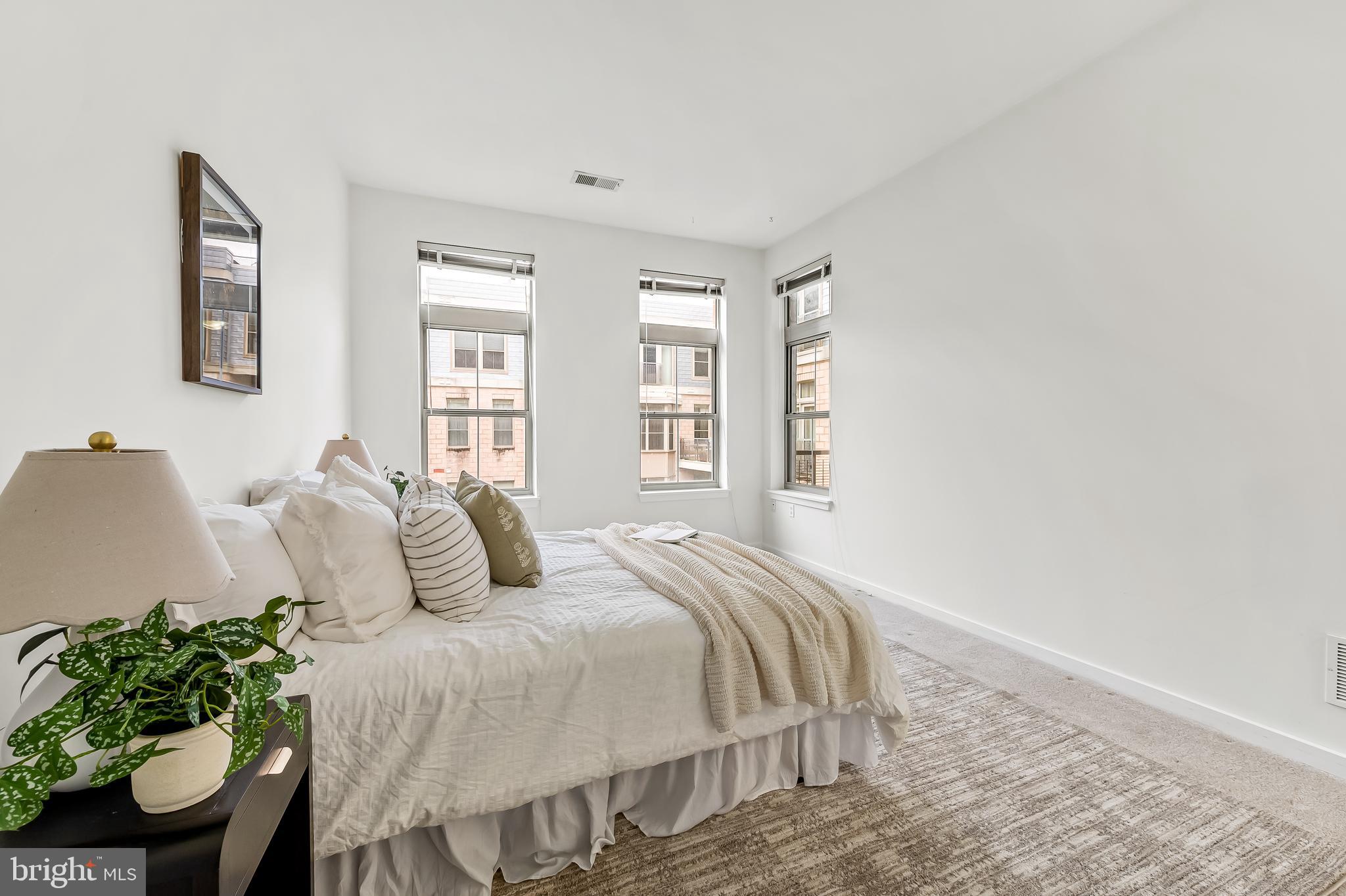 1209 North Charles Street, Unit 314 Baltimore, MD 21201 - Photo 20 of 34 a bedroom with a bed and a window