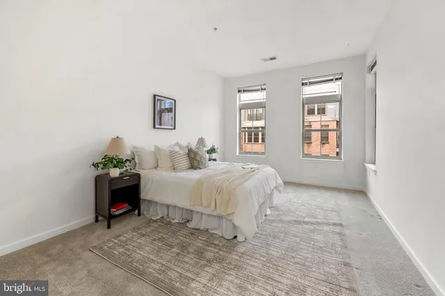 a bed room with a bed and a window