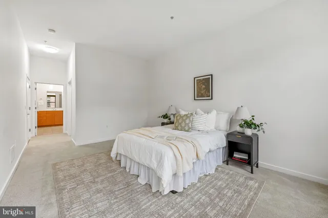 a bedroom with a bed and a lamp