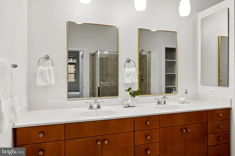 a bathroom with double vanity sinks and a mirror