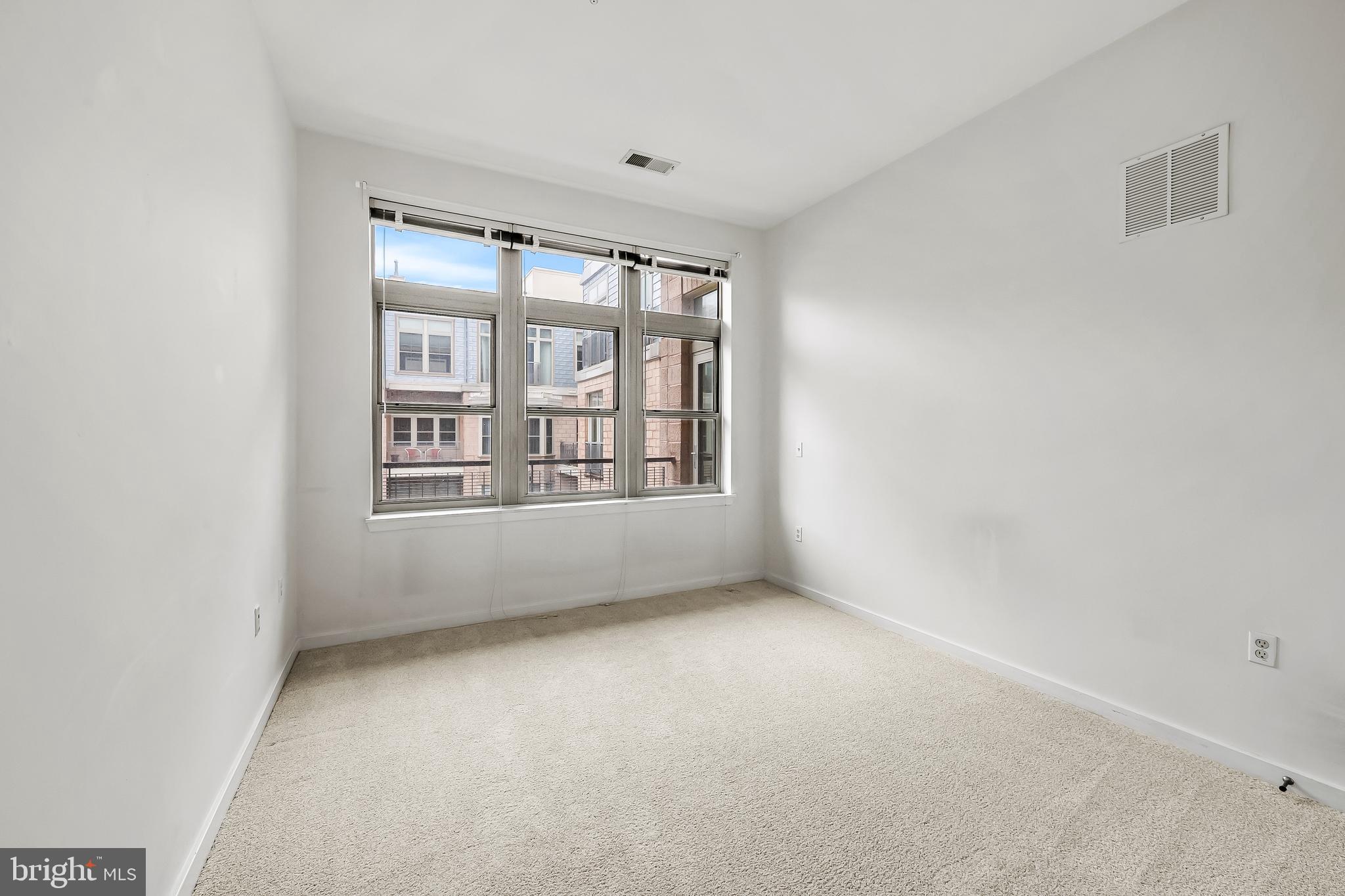 1209 North Charles Street, Unit 314 Baltimore, MD 21201 - Photo 26 of 34 an empty room with windows