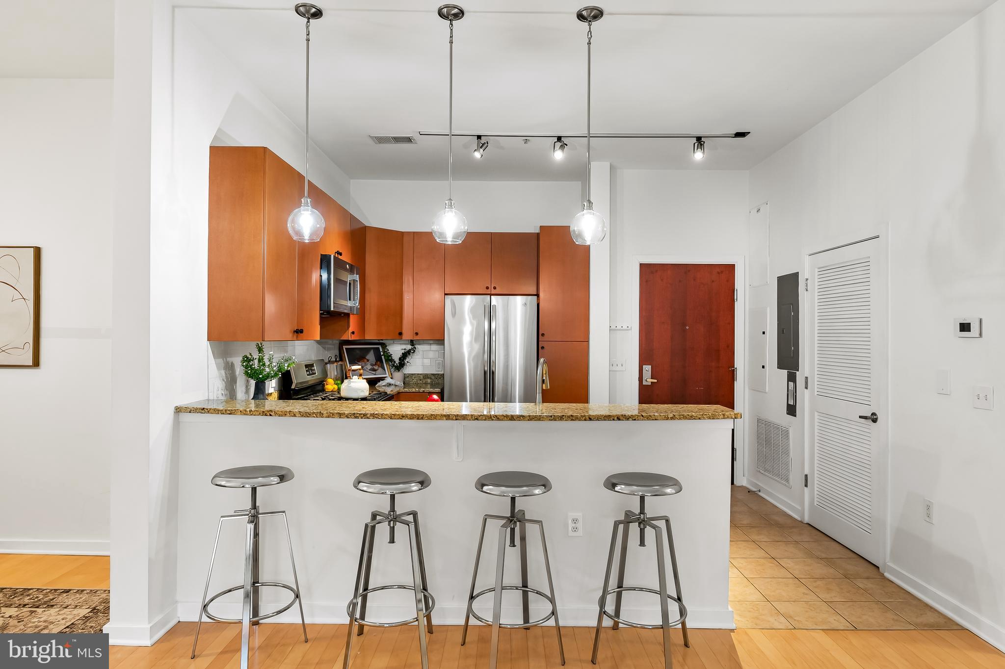 1209 North Charles Street, Unit 314 Baltimore, MD 21201 - Photo 6 of 34 a view of a kitchen with furniture and wooden floor