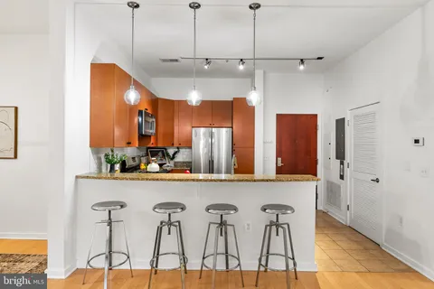 a view of a kitchen with furniture and wooden floor